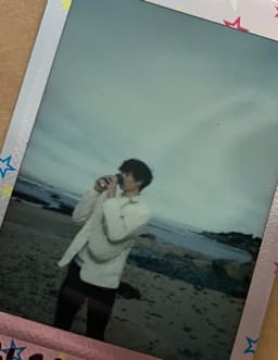 a person drinking coffee on a beach